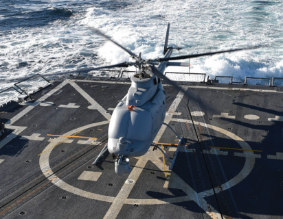 Military helicopter landing on navy ship