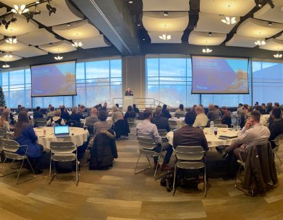 Photo from our Tech Strategy event, showing a room at Meijer Gardens full of people seated at numerous tables.