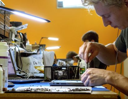 Man repairing phone at workstation