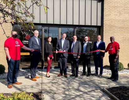 L3Harris Technologies, Inc with The Right Place President/CEO Randy Thelen in front of new building for ribbon cutting ceremony