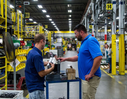 Two men on manufacturing plant floor
